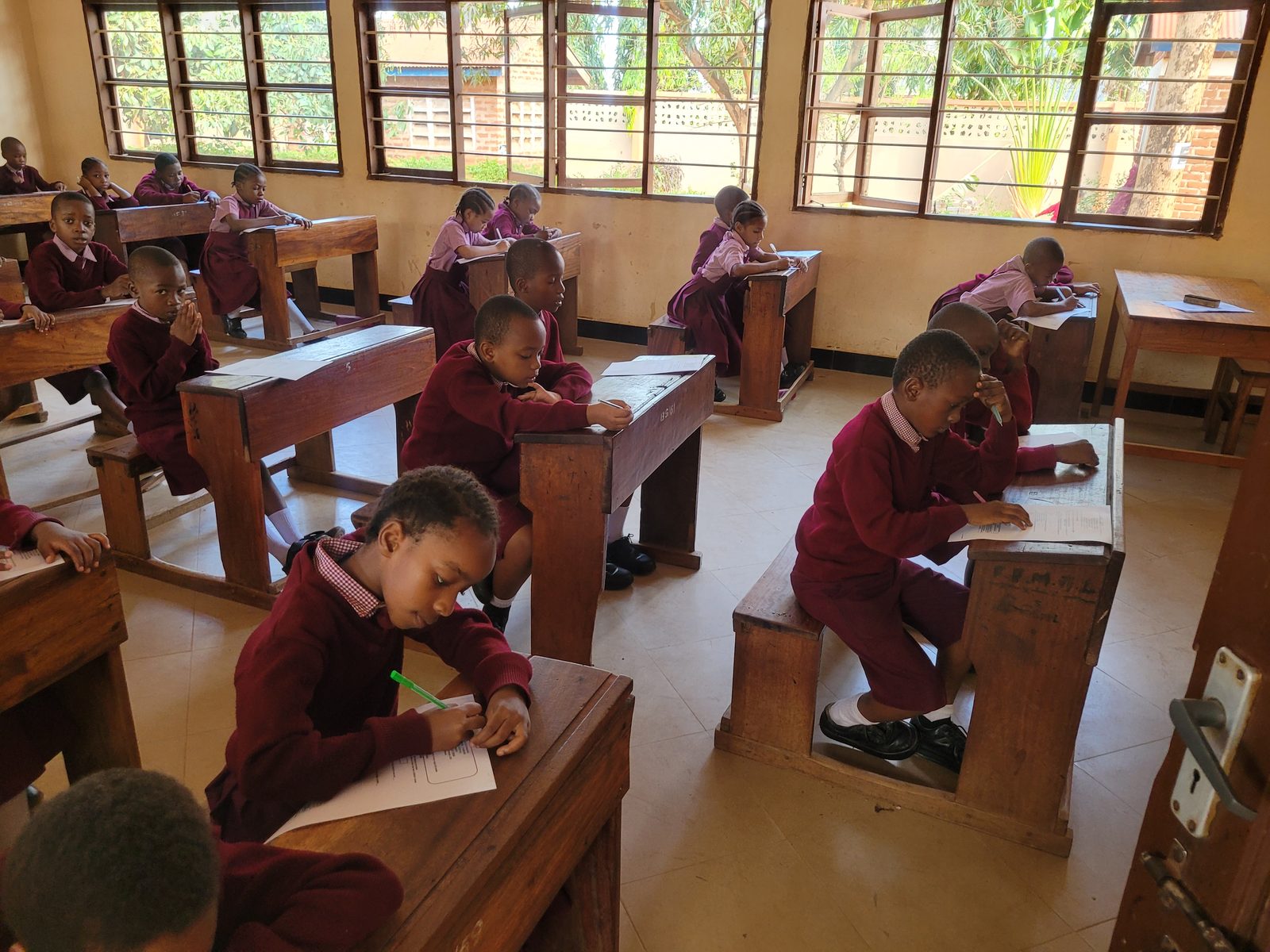 Primary pupils writing at their desks